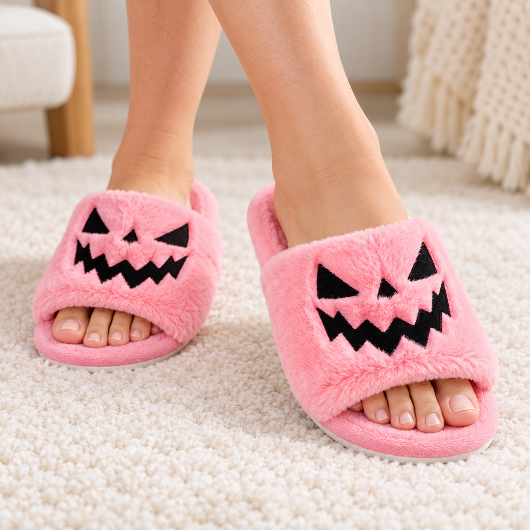 Pink plush Halloween slippers with black jack-o&