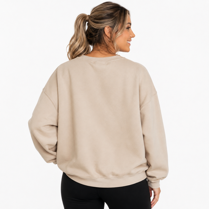 Back view of beige Halloween pumpkin sweatshirt showing the plain rear design on a clean white studio background.