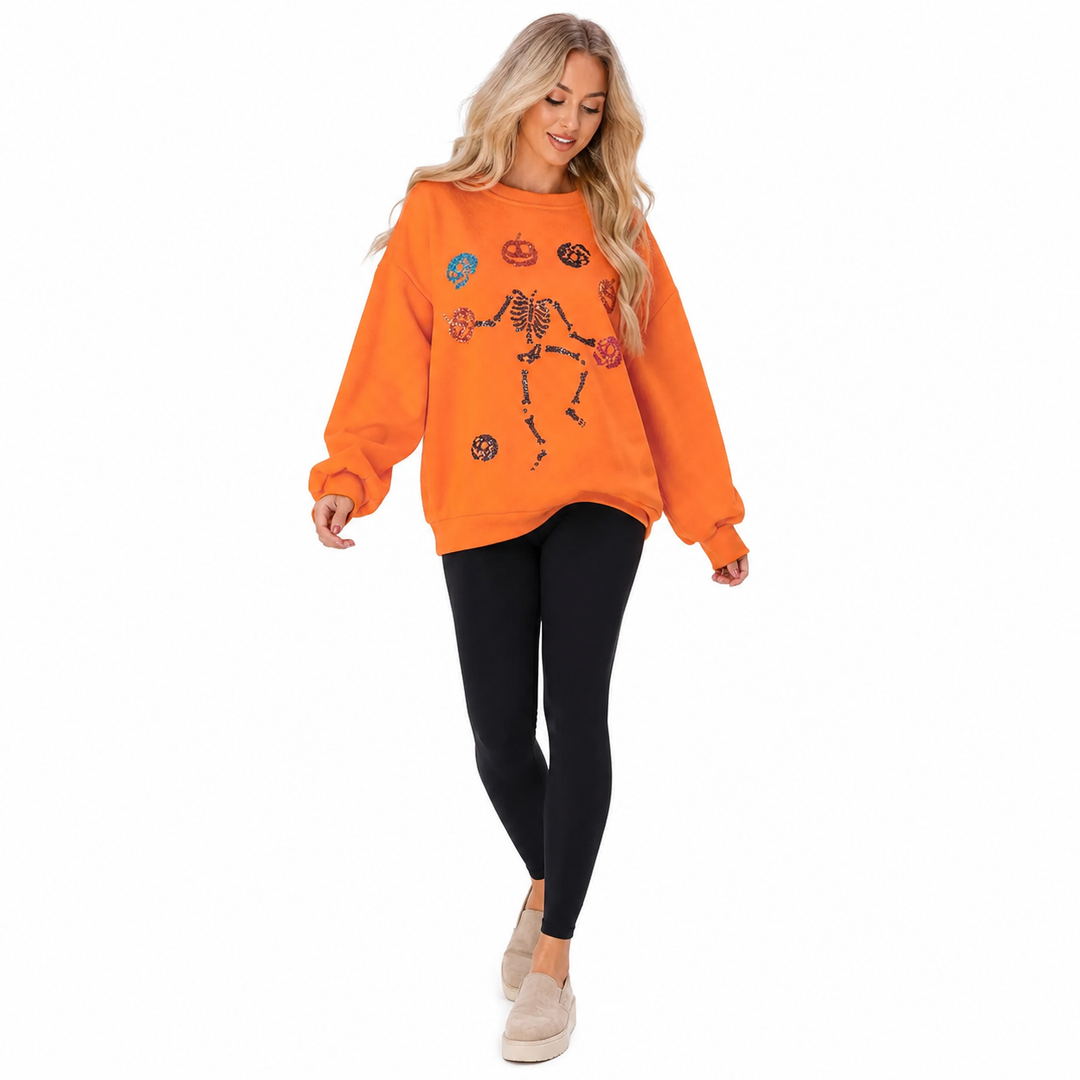 Orange skeleton pumpkin sweatshirt in standing pose, highlighting seasonal front design against a clean white studio backdrop