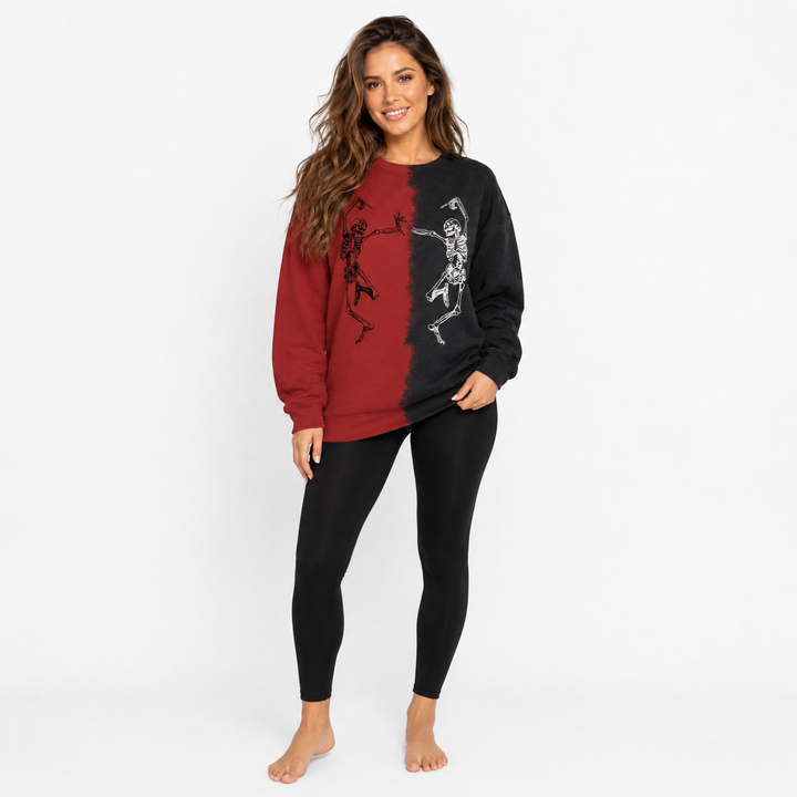 Woman wearing red and black Halloween skeleton sweatshirt in a full-body studio view on a clean white background.