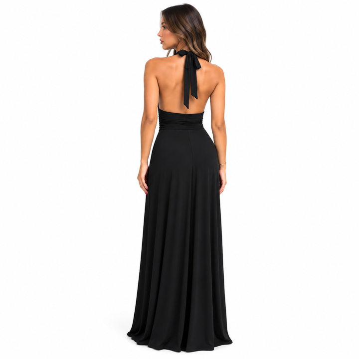 Black backless maxi dress shown from the rear on a full-body model