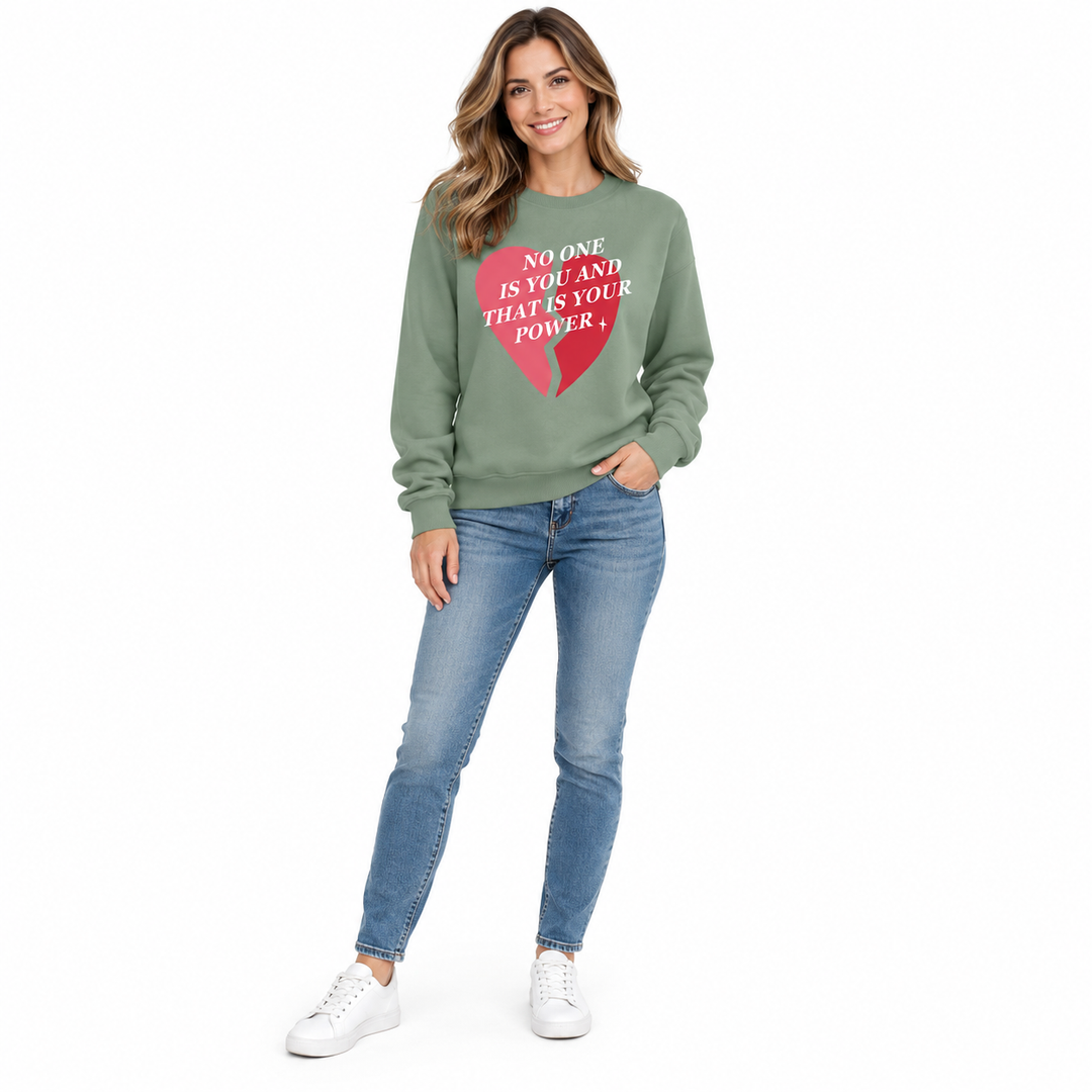 Olive green printed sweatshirt on a full-length female model with jeans, showing the front design on a white studio backdrop.