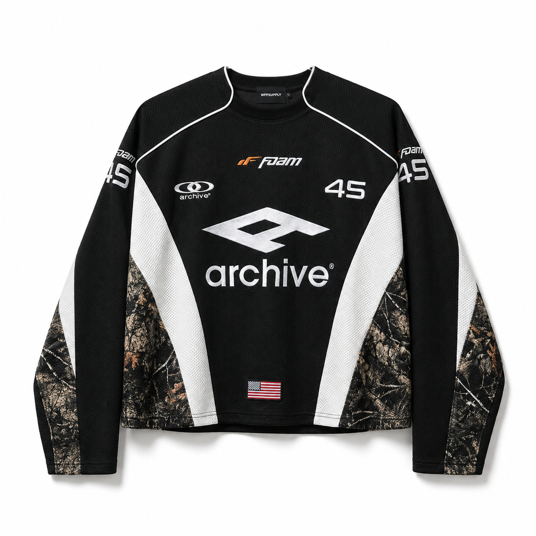 Hip hop hoodie for men in black with archive graphic, white panels and camouflage sleeves on a clean white studio background.