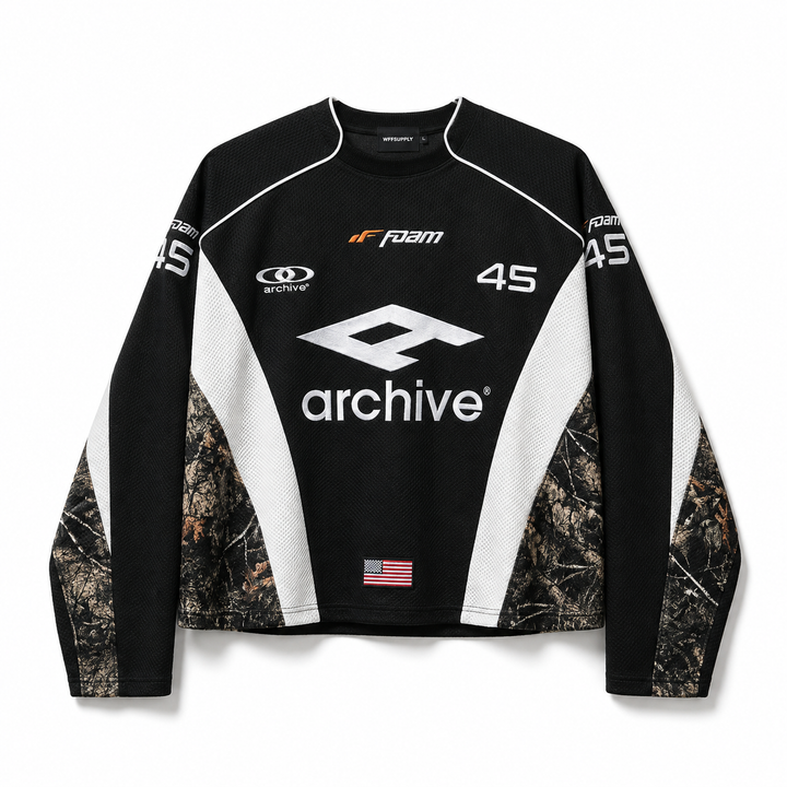 Hip hop hoodie for men in black with archive graphic, white panels and camouflage sleeves on a clean white studio background.