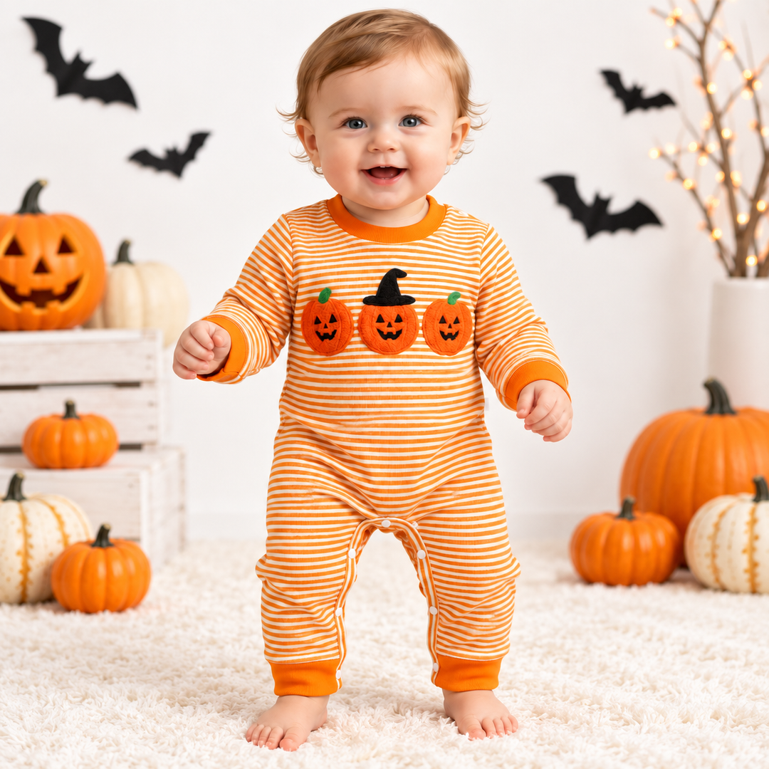 Orange striped baby Halloween jumpsuit in seasonal pumpkin setting
