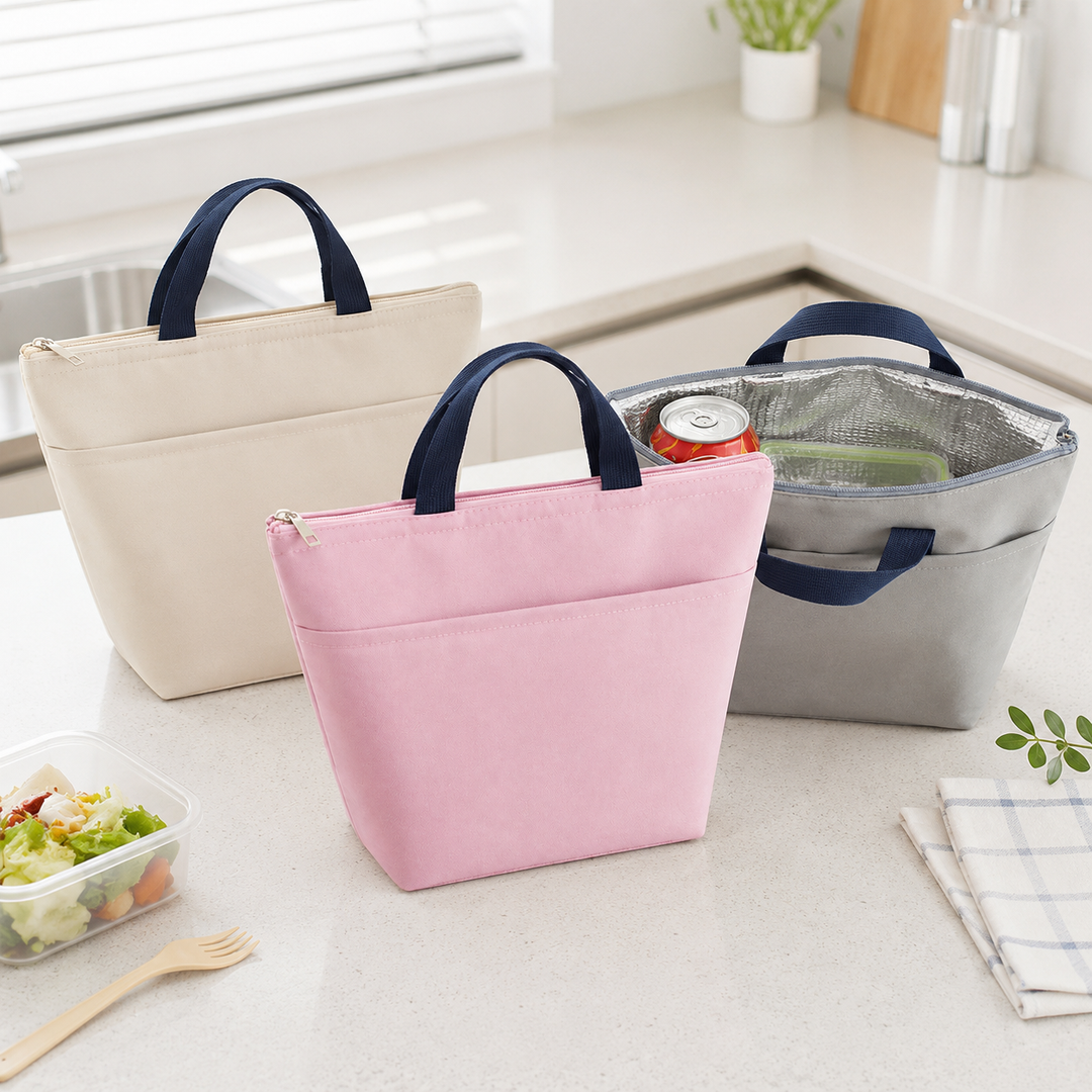 Pink, beige and gray insulated lunch totes in a bright kitchen scene, with one open to show the reflective PEVA interior shot