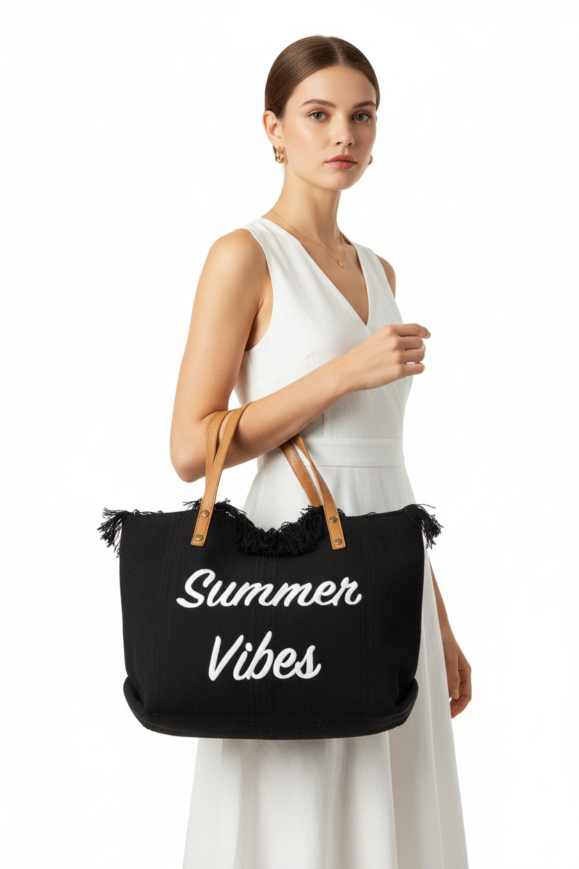 Woman holding a black tote bag with 'Summer Vibes' text against a white background