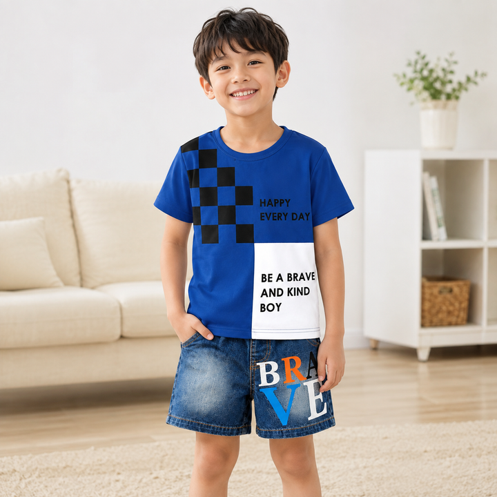 Young boy wearing navy graphic tee and denim shorts in a bright indoor setting, showing the coordinated kids outfit.