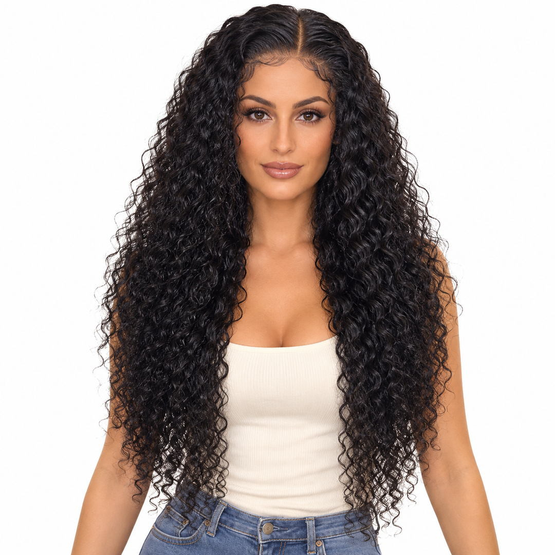 Front view of a natural-black human hair wig on an adult woman, with defined curls, an ivory top and white studio background.