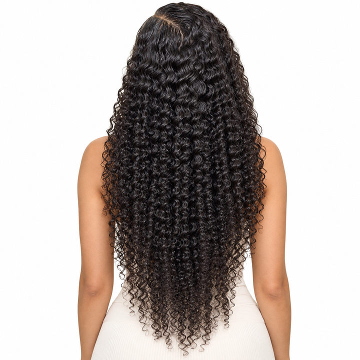 Back view of natural-black curly wig on an adult woman, showing the curl pattern and visible ends against the white backdrop.