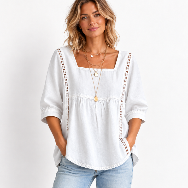 White blouse reference on a model showing the square neckline, gathered seam and vertical lace patchwork trim.