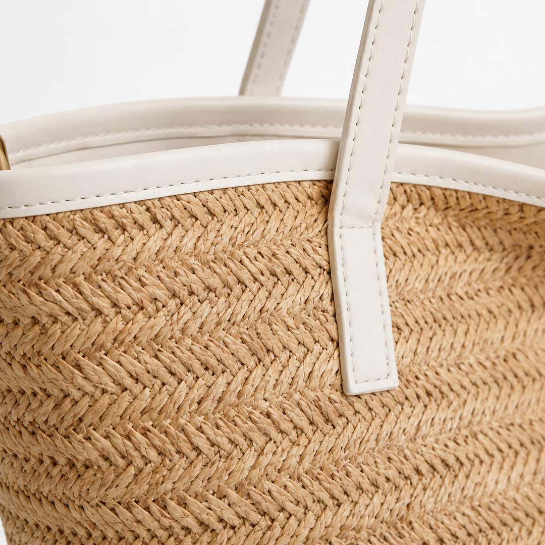 Close-up of the woven texture, white trim, stitching and handle attachment on the light khaki Bride tote bag