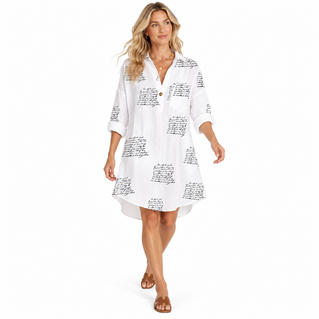 Letter Print Dress in a walking pose with white base, black script print, rolled sleeves and easy everyday styling