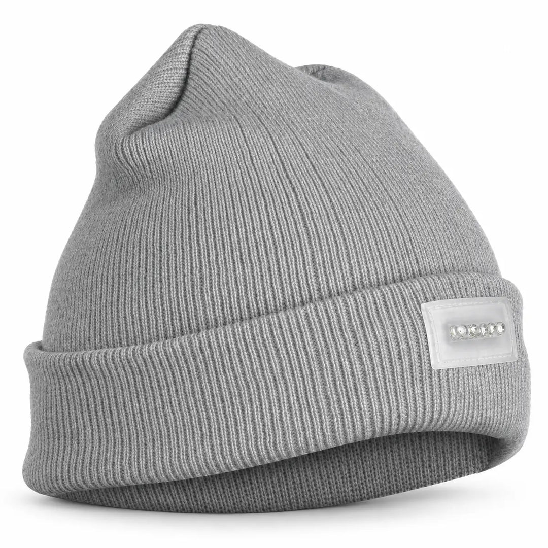 Lighted knit cap in a clean studio view, showing its soft ribbed texture, folded cuff and transparent five-light front panel.