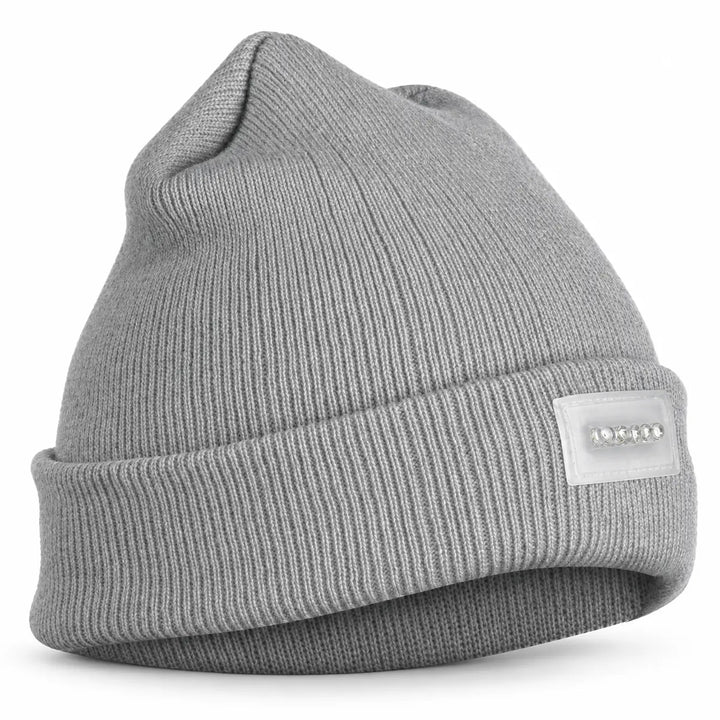 Lighted knit cap in a clean studio view, showing its soft ribbed texture, folded cuff and transparent five-light front panel.