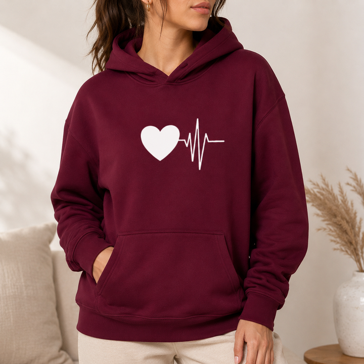 Burgundy graphic hoodie on female model with heartbeat heart graphic and kangaroo pocket, shown clearly for visual reference.