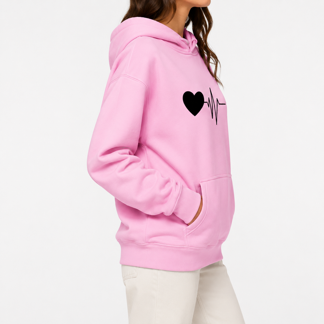 Pink love hoodie side fit view on female model with black heartbeat graphic and hooded pullover shape for shopping reference.