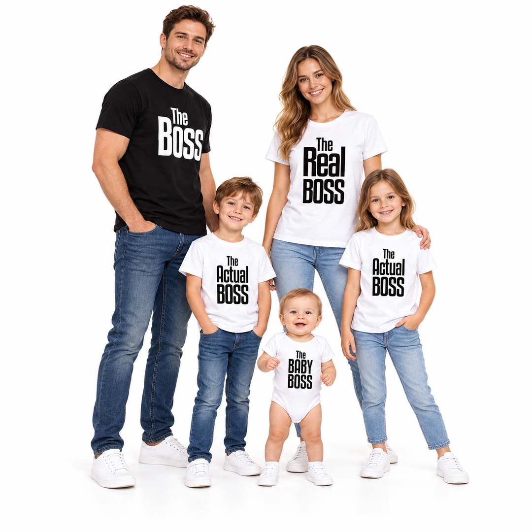 Full-body family wearing black and white Boss graphic shirts and a baby romper, styled with blue denim in plain white studio.