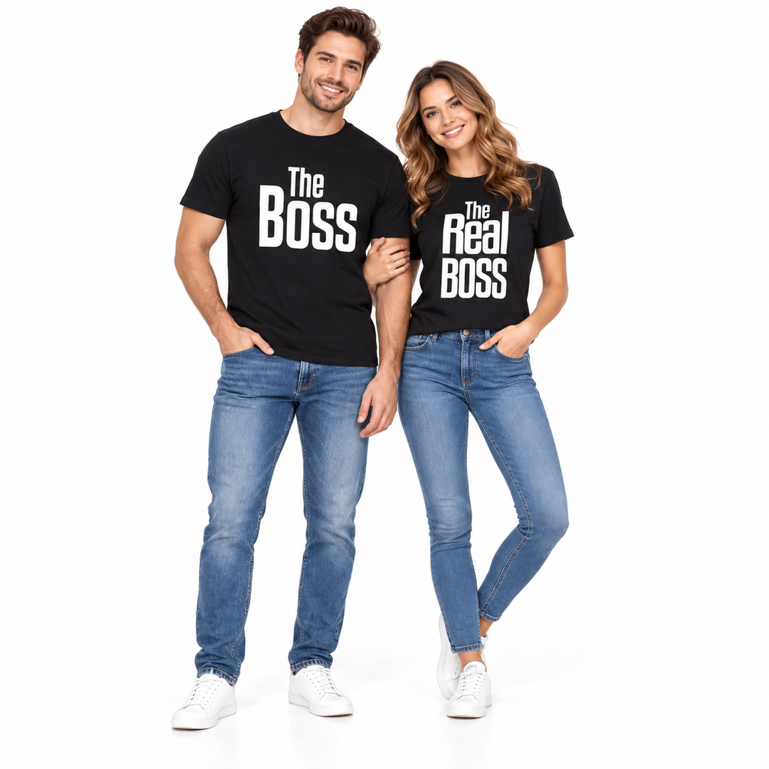 Full-body adult couple wearing black The Boss and The Real Boss graphic T-shirts with jeans and sneakers on a white backdrop.
