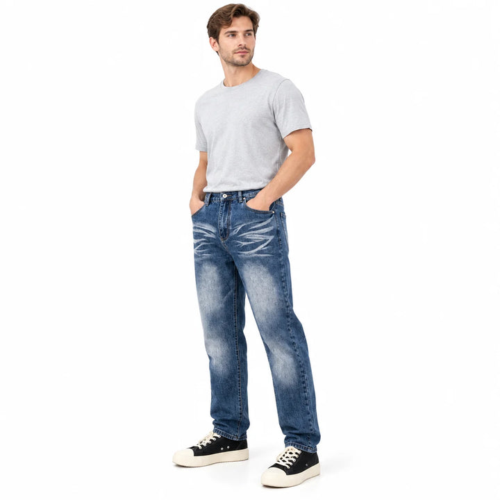 Male model in a side-front pose wearing blue loose straight-leg jeans with faded thighs, a grey tee and black canvas sneakers