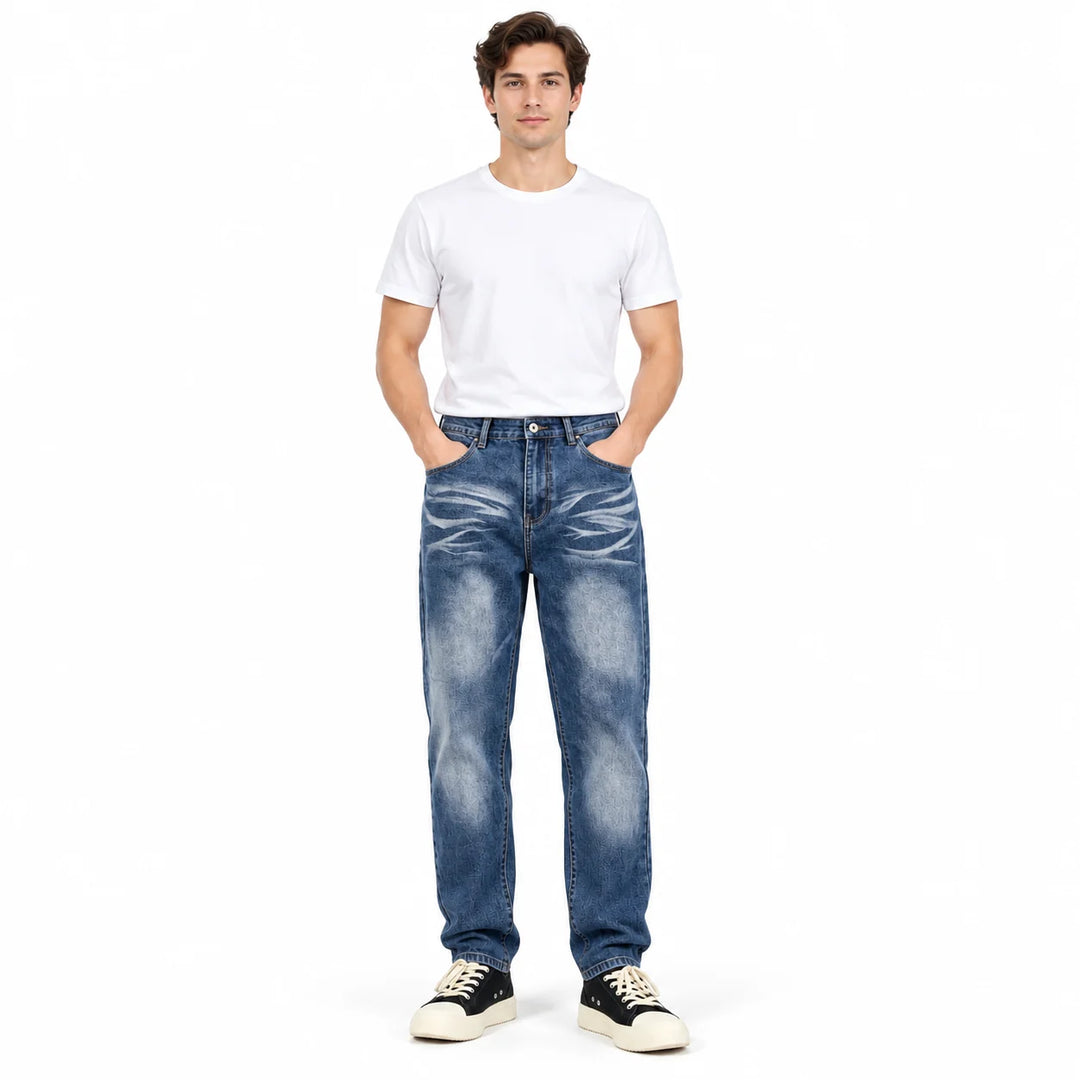 Front full-body male model wearing Blue washed denim jeans with a plain white T-shirt and black sneakers on white background.