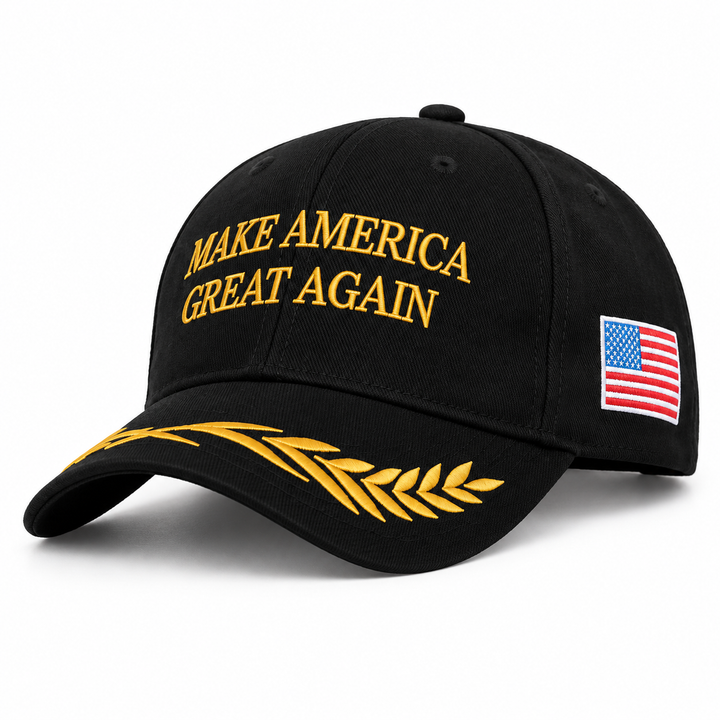 Black embroidered baseball cap with gold front lettering, gold leaf detail on the brim and a US flag side patch.