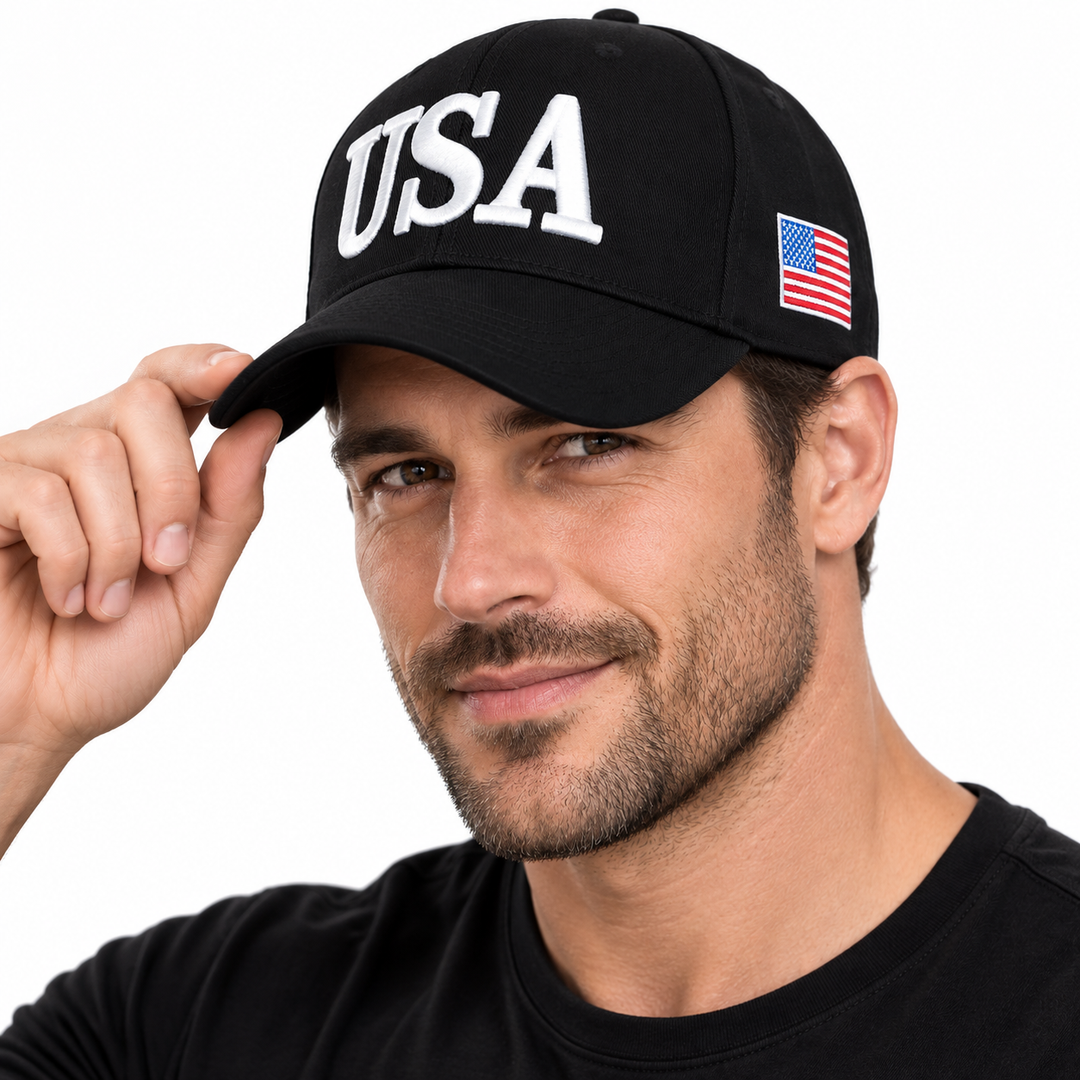 Male model wearing a black baseball cap with white USA embroidery and a small US flag side patch.