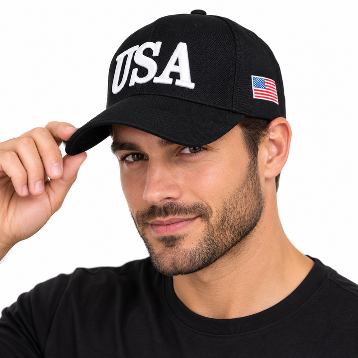 Male model wearing a black USA embroidered baseball cap with a US flag side patch on a white background.