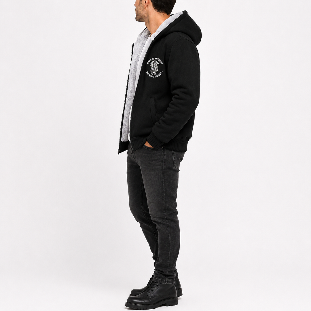 Black hooded fleece jacket shown from the side on a male model, for clear view of the profile, hood shape, and sleeve length.