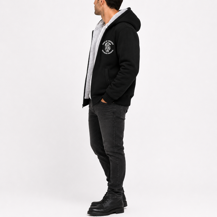 Black hooded fleece jacket shown from the side on a male model, for clear view of the profile, hood shape, and sleeve length.