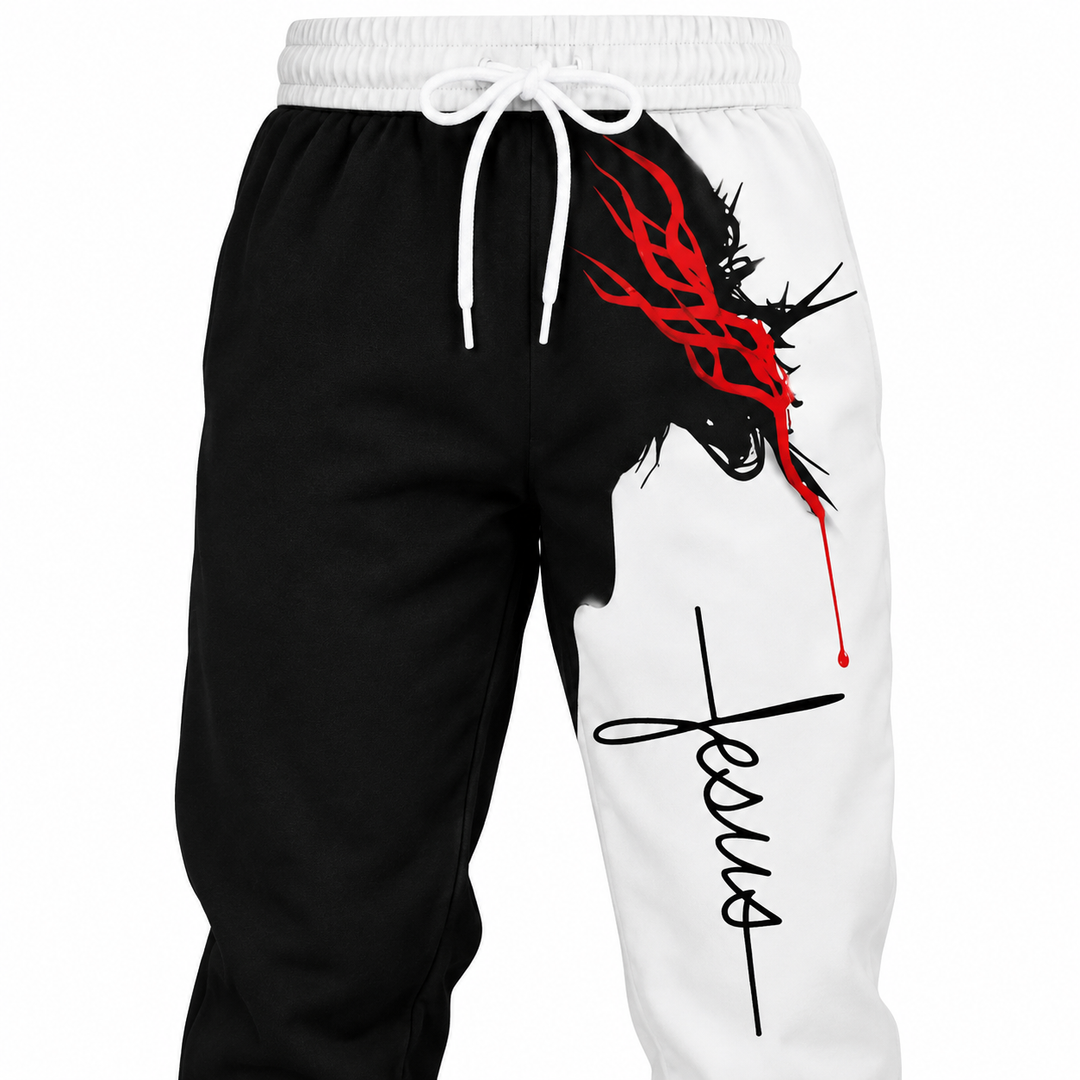 Close-up of the white waistband and drawstring on black and white Jesus print pants, with the red head artwork and lettering.