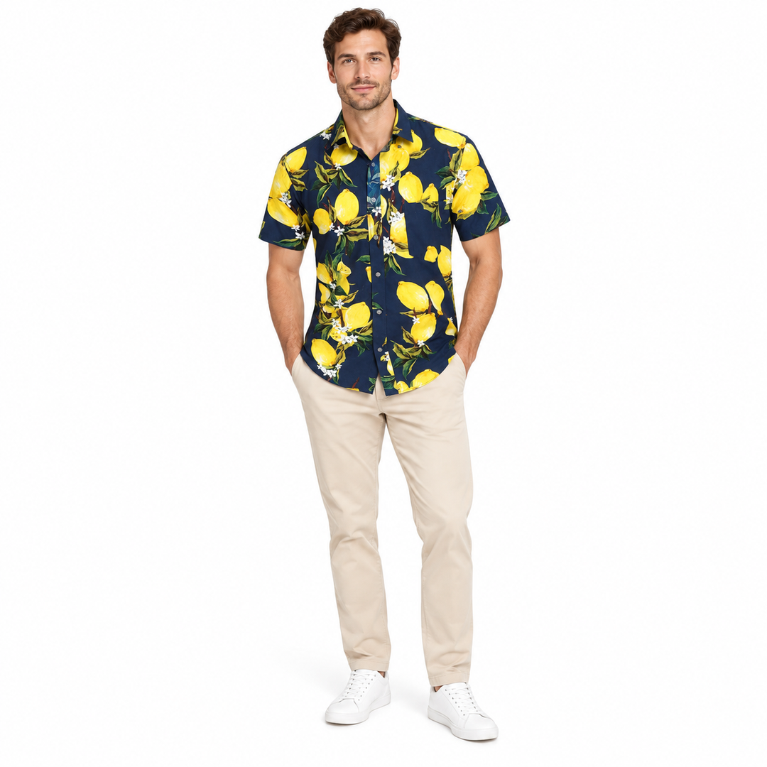 Model wearing a navy lemon print shirt in a full-body front view with trousers and shoes visible on a plain white background.