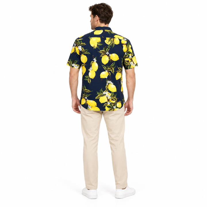 Model wearing a navy lemon print shirt shown from the back in a full-body studio photograph against a plain white background.