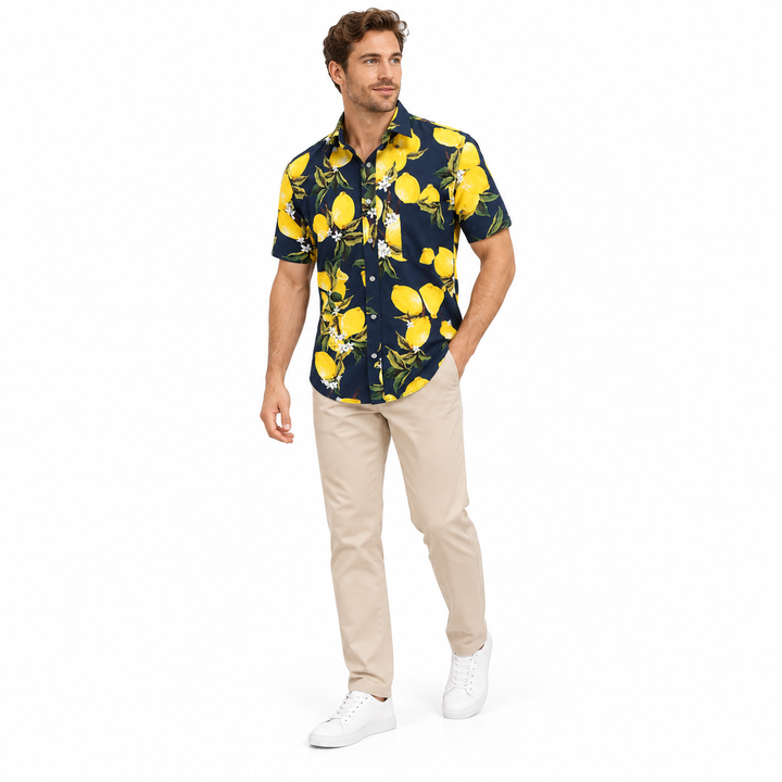 Model wearing a navy fruit print shirt in a three-quarter full-body view showing the printed top on a plain white background.