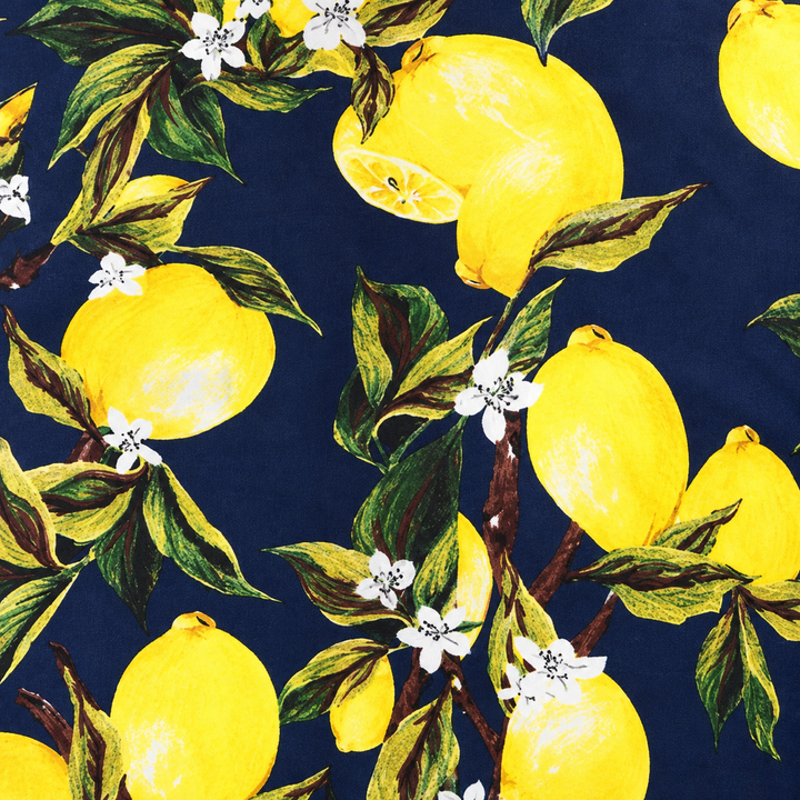 Close-up of the navy citrus print shirt, showing yellow lemons, green leaves and white flowers across the shirt&