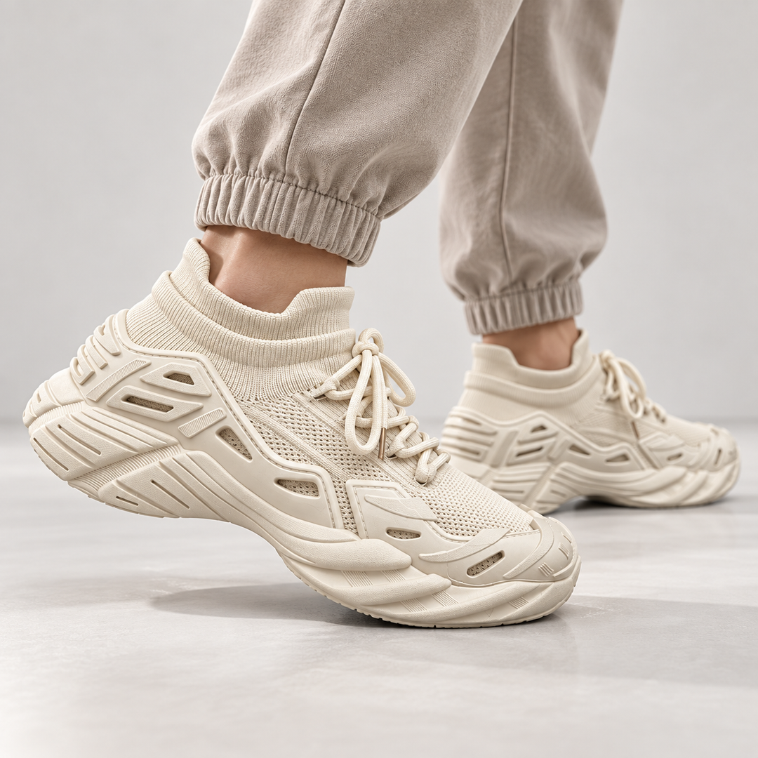 Beige running shoes shown on foot in a clean studio movement view