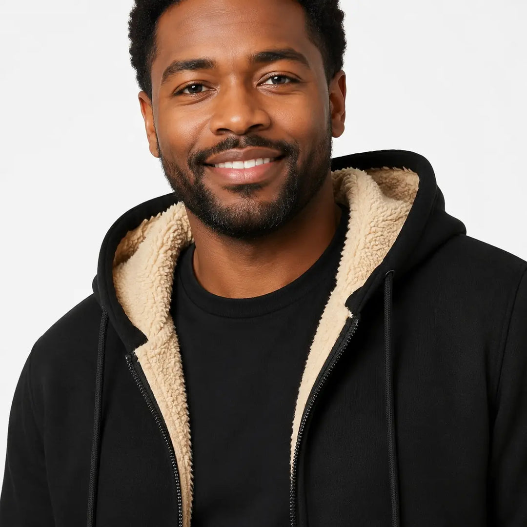 Black sherpa lined zip hoodie close-up on a male model, highlighting beige lining, zipper teeth, outer texture and stitching.