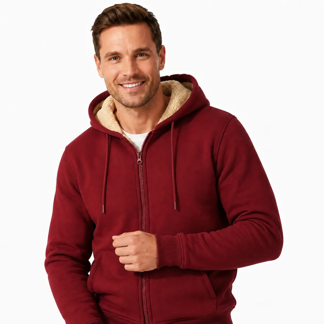 Burgundy zip hoodie close-up on a male model showing sherpa hood lining, drawstrings, zipper, pocket opening and cuff finish.