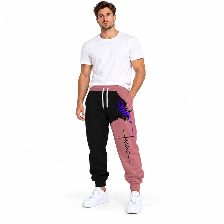 Male model wearing pink Jesus print drawstring pants, with a white tee and white sneakers, against a white studio background.