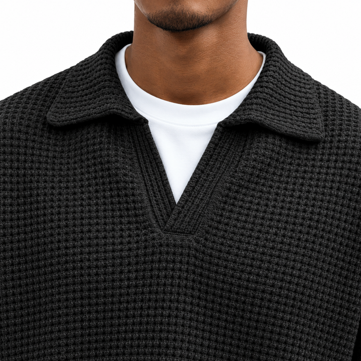 Detail view of the open lapel collar, neck stitching and waffle texture on the black men&