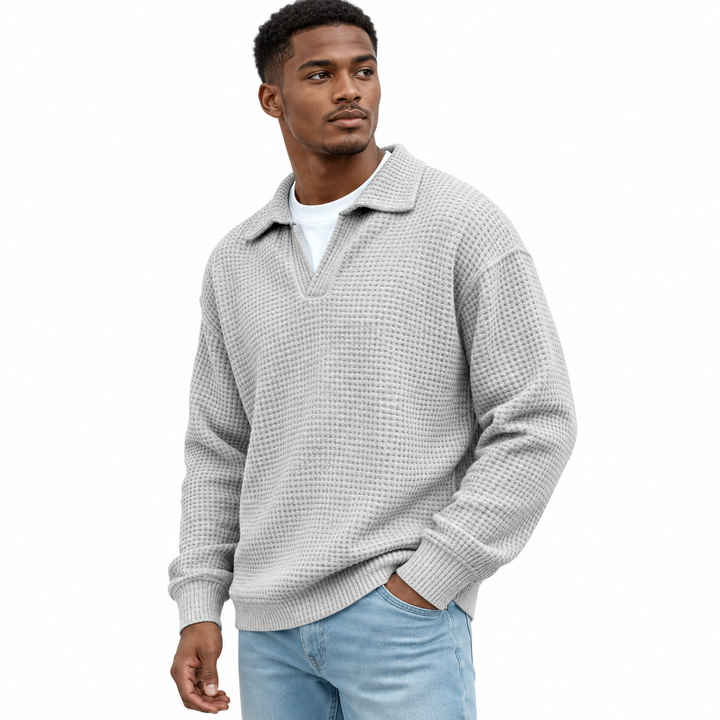 Light gray long sleeve polo with waffle texture, open lapel collar and loose silhouette shown in an easy standing model pose.