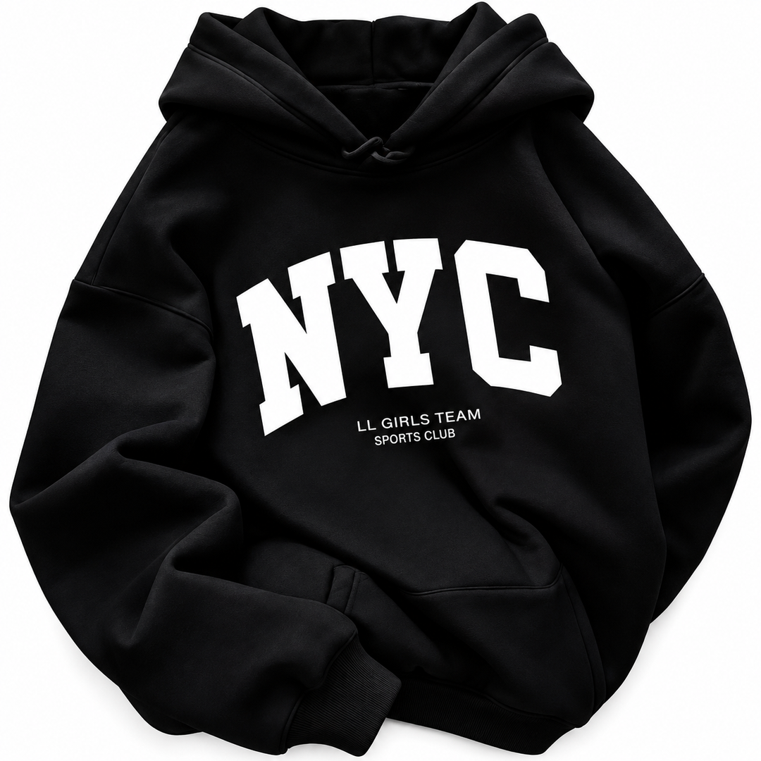 Close view of the black hoodie with white NYC lettering, a kangaroo pocket and drawstrings against a white studio background.