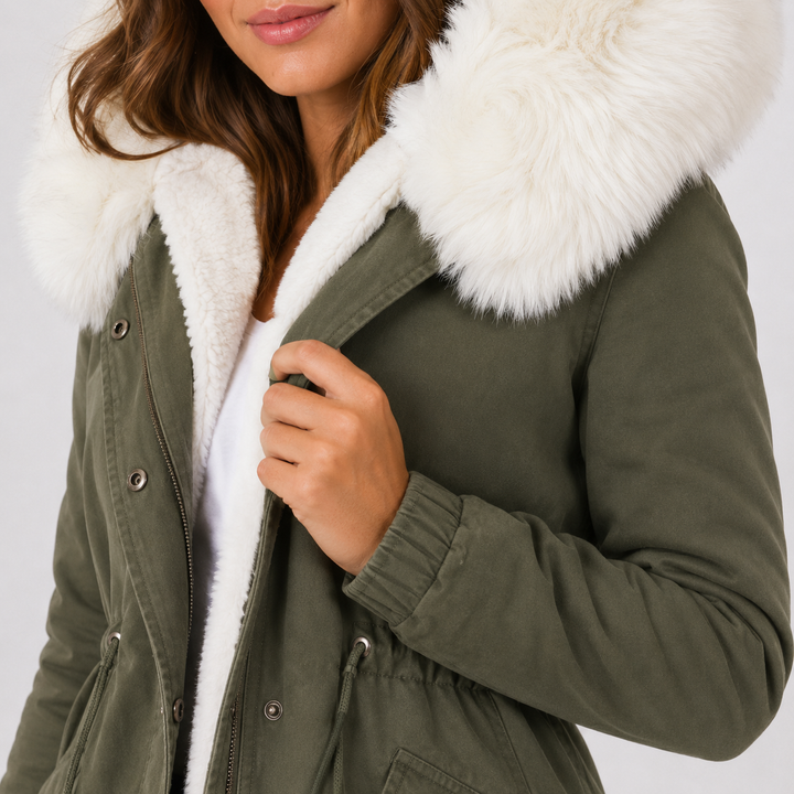 Olive green coat close-up showing white hood trim, plush lining, front snaps, visible seams and waist drawstring detail view.