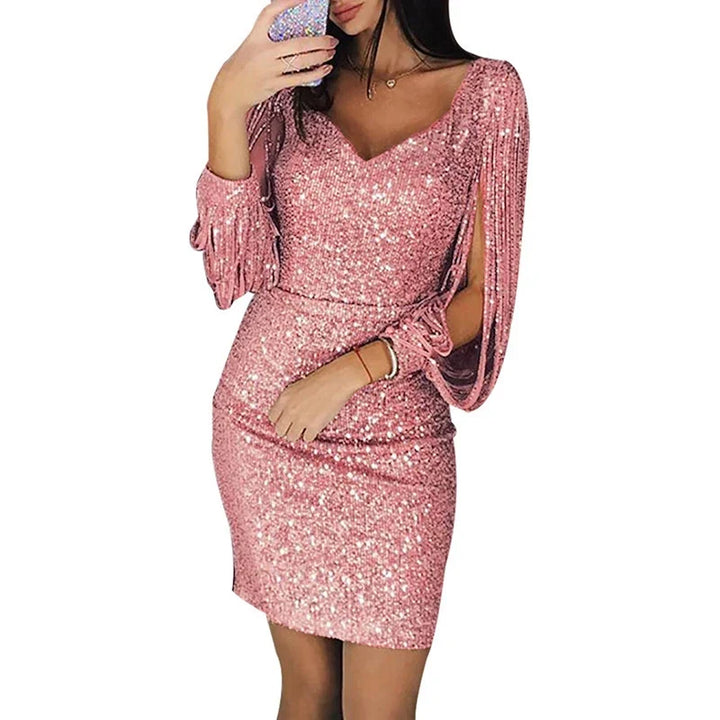 Pink V-neck mini dress in a white background cutout showing a slim fit, tassel sleeves and a shimmer finish for outfit ideas.