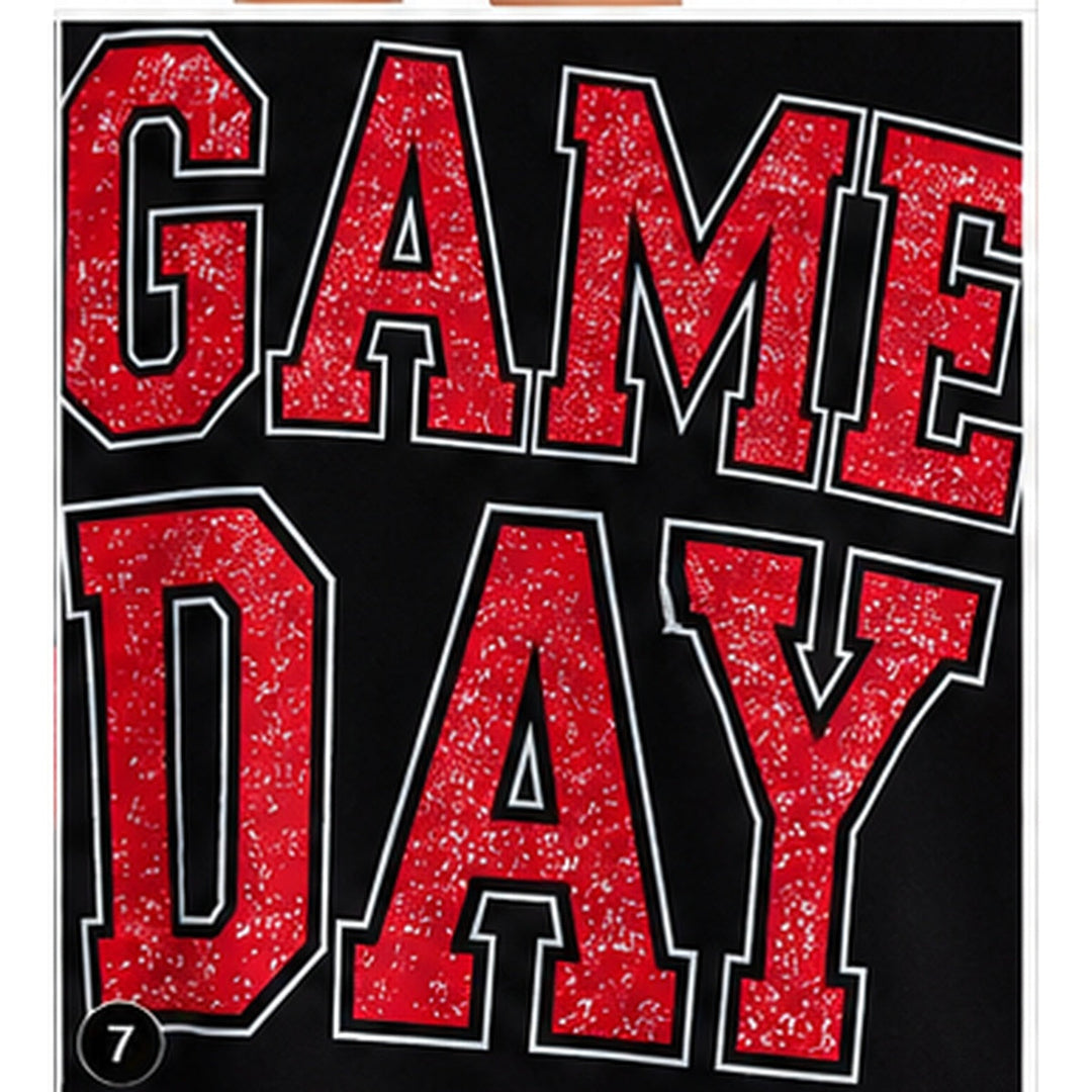 Close-up of distressed red GAME DAY varsity lettering with contrast outlines on the black sweatshirt front.
