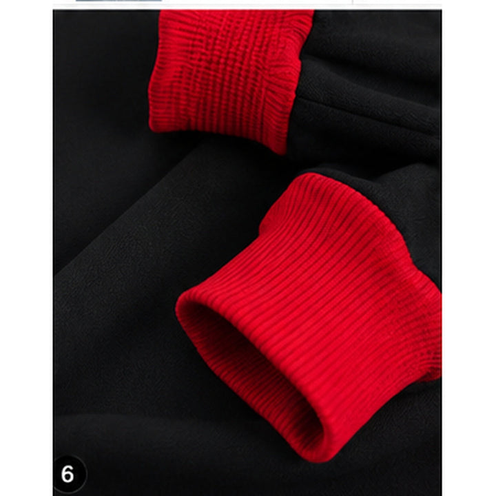 Close-up of the red ribbed cuff and black sweatshirt fabric from the GAME DAY sweatshirt on a clean white product presentation.
