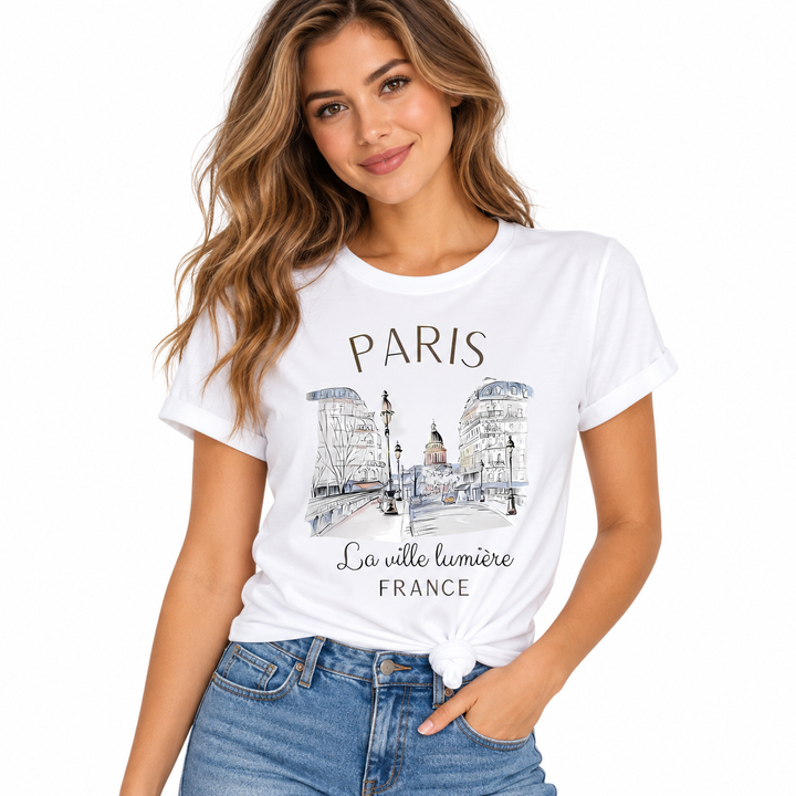 Paris graphic T-shirt for women styled with a front knot, white crew neck tee, Paris city sketch print and blue denim outfit.