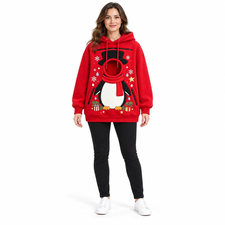 Full-body model wearing a red penguin pet pouch hoodie with long sleeves, circular front opening and Christmas gift graphics.