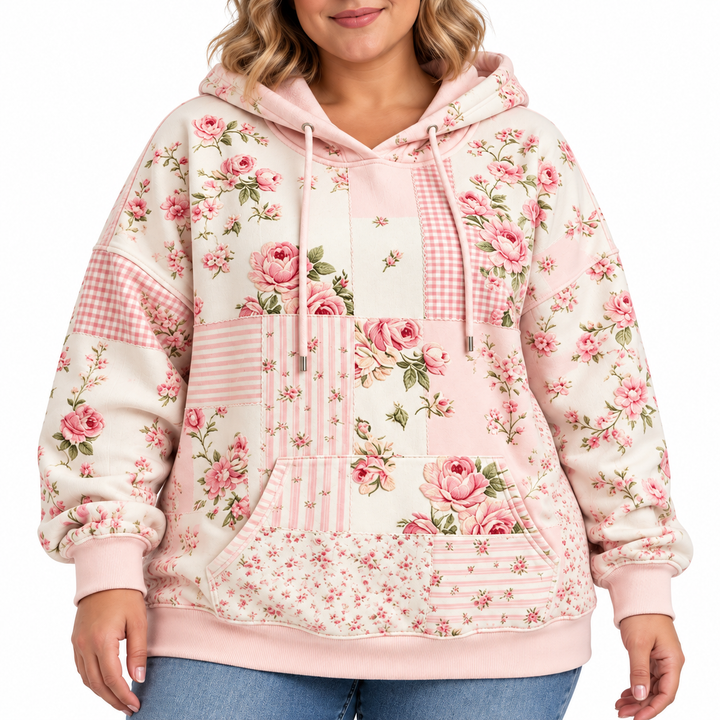 Plus size floral hoodie in blush pink, close-up showing rose print, drawstrings, kangaroo pocket and ribbed cuffs