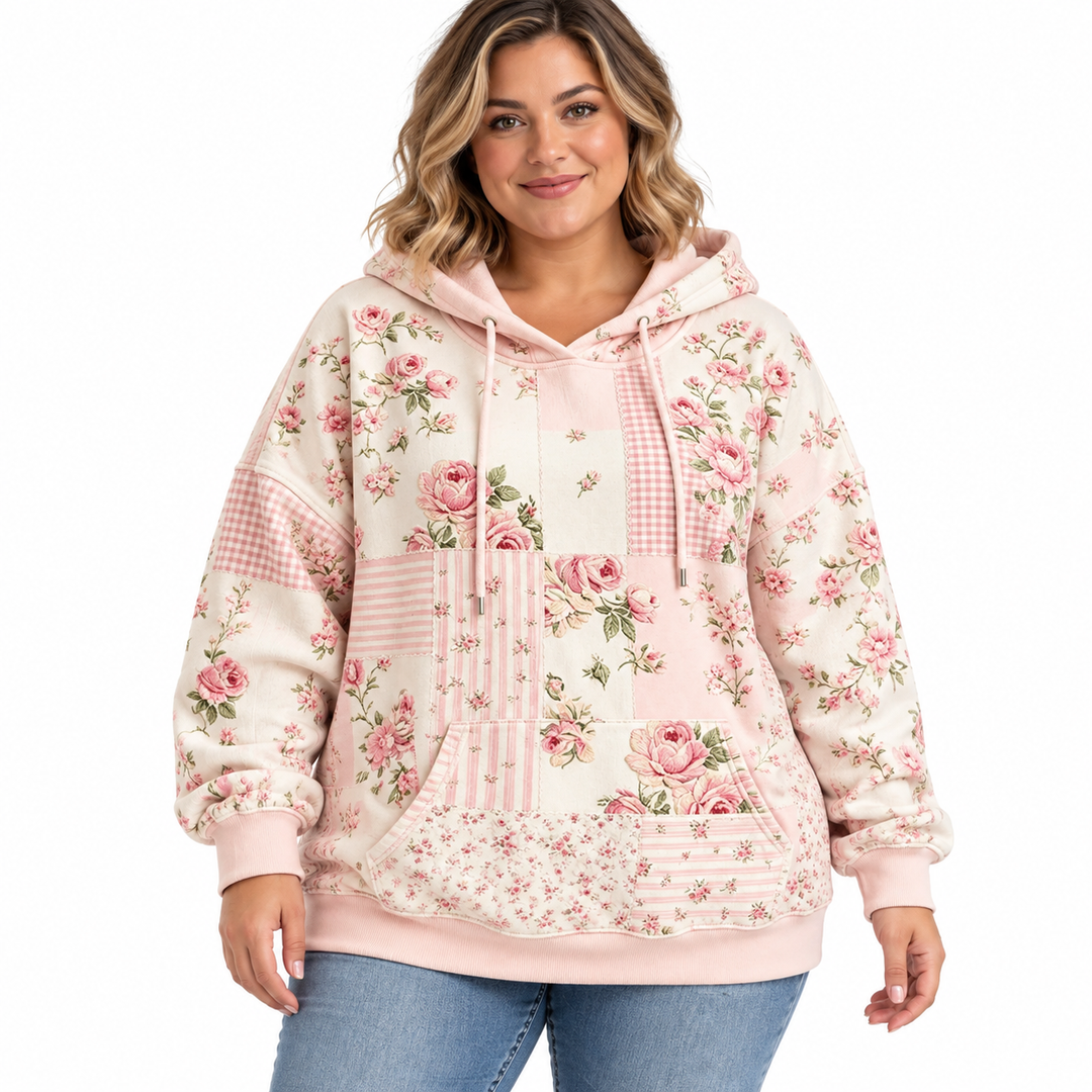 Plus size floral hoodie in blush pink with drawstrings and a kangaroo pocket, shown on a model against white